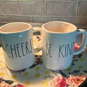 2 Rae Dunn mugs. BE KIND and CHEERS